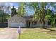 Charming single-story home features a two-car garage, inviting front porch, and well-manicured lawn at 1222 W Wylie Bridge Rd, Woodstock, GA 30188