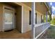 This lovely home features a cozy front porch, wood-like vinyl siding, and decorative dark shutters at 1222 W Wylie Bridge Rd, Woodstock, GA 30188