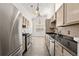 Bright kitchen featuring stainless steel appliances and laminate flooring at 1222 W Wylie Bridge Rd, Woodstock, GA 30188