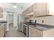 Well-lit kitchen featuring stainless steel appliances, tile backsplash, and ample counter space at 1222 W Wylie Bridge Rd, Woodstock, GA 30188