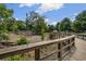 A view from the wood bridge of the playground with a climbing structure, and rock tunnel at 1222 W Wylie Bridge Rd, Woodstock, GA 30188