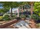 Landscaped street view with brick sidewalk and decorative plantings outside Main & Mill Restaurant & Bar at 1222 W Wylie Bridge Rd, Woodstock, GA 30188