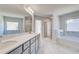 Bright bathroom with double vanity, separate tub and shower, and marble flooring at 128 Felicity Pike, Locust Grove, GA 30248