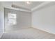 Bedroom featuring light colored walls, carpet and a window, with neutral decor at 128 Felicity Pike, Locust Grove, GA 30248