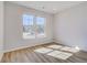 Bright bedroom featuring wood floors, two windows with natural light, and neutral color palette at 128 Felicity Pike, Locust Grove, GA 30248