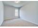 An empty bedroom with a window and neutral carpet at 128 Felicity Pike, Locust Grove, GA 30248