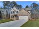 Charming two-story brick home with a well-manicured lawn and attached two-car garage at 128 Felicity Pike, Locust Grove, GA 30248