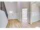 Bright foyer with hardwood floors, staircase, and access to multiple rooms, highlighting open floorplan at 128 Felicity Pike, Locust Grove, GA 30248