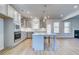 Modern kitchen with island, stainless steel appliances, gray cabinets and open layout to living space at 128 Felicity Pike, Locust Grove, GA 30248