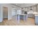 Modern kitchen with island, stainless steel appliances, gray cabinets and open layout to dining space at 128 Felicity Pike, Locust Grove, GA 30248