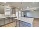 A spacious kitchen with a large island, stainless steel appliances, and light gray cabinets at 128 Felicity Pike, Locust Grove, GA 30248