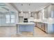 This open concept kitchen features gray cabinets, stainless steel appliances and a large island at 128 Felicity Pike, Locust Grove, GA 30248