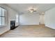 An open concept living room featuring a fireplace and lots of natural light at 128 Felicity Pike, Locust Grove, GA 30248