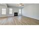 An open concept living room featuring a fireplace and lots of natural light at 128 Felicity Pike, Locust Grove, GA 30248
