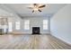 An open concept living room featuring a fireplace and lots of natural light at 128 Felicity Pike, Locust Grove, GA 30248