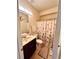 Well-lit bathroom featuring a vanity with sink and a shower with a floral butterfly curtain at 2269 Reddy Farm Ln, Grayson, GA 30017