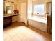 Bathroom featuring a tiled floor, vanity, soaking tub, and a glass shower at 2269 Reddy Farm Ln, Grayson, GA 30017