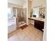 Bathroom with bathtub, shower, vanity with sink, and natural light at 2269 Reddy Farm Ln, Grayson, GA 30017