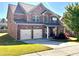 Attractive two-story brick home with a well-maintained yard and a double-car garage at 2269 Reddy Farm Ln, Grayson, GA 30017