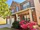 Lovely brick home featuring a covered front porch, two-car garage, and mature landscaping at 2269 Reddy Farm Ln, Grayson, GA 30017