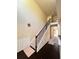 Elegant staircase featuring dark wood floors and white wainscoting at 2269 Reddy Farm Ln, Grayson, GA 30017