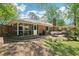 Backyard with screened in porch, patio with outdoor seating, and mature trees at 2324 Bry Mar Ne Dr, Atlanta, GA 30345