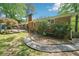 Brick home with a landscaped backyard, stone pathway and outdoor seating area at 2324 Bry Mar Ne Dr, Atlanta, GA 30345