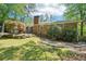 Backyard with mature landscaping, outdoor seating area, and a brick home exterior at 2324 Bry Mar Ne Dr, Atlanta, GA 30345