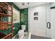 Bright bathroom featuring stylish floral wallpaper, toilet, and glass-enclosed shower with tiled niche at 2324 Bry Mar Ne Dr, Atlanta, GA 30345