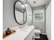 Well-lit bathroom features a white vanity with a single sink, sleek fixtures, and a modern tile shower with a curtain at 2324 Bry Mar Ne Dr, Atlanta, GA 30345