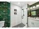 Beautiful bathroom with floral wallpaper, tiled shower with niche, and modern vanity at 2324 Bry Mar Ne Dr, Atlanta, GA 30345