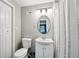 Neutral bathroom with a mirrored oval, vanity and sink, toilet, and shower with curtain at 2324 Bry Mar Ne Dr, Atlanta, GA 30345