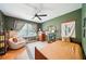 Cozy bedroom with olive-green walls, neutral decor, a plush chair, and a comfortable bed illuminated by natural light at 2324 Bry Mar Ne Dr, Atlanta, GA 30345