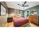 Cozy bedroom with hardwood floors, a ceiling fan, bedside tables, and a glimpse into an adjacent bathroom at 2324 Bry Mar Ne Dr, Atlanta, GA 30345