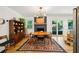 Cozy dining area with a brick fireplace, unique lighting, and hardwood flooring at 2324 Bry Mar Ne Dr, Atlanta, GA 30345