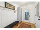 Inviting entryway boasting coat hooks, storage cabinets, a black bench, and stylish decor with a view of the back porch at 2324 Bry Mar Ne Dr, Atlanta, GA 30345