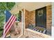 Close up of front porch with beautiful brick detail, US flag, and welcome mat at 2324 Bry Mar Ne Dr, Atlanta, GA 30345