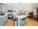 Bright kitchen features stainless steel appliances, center island with seating, and open dining area at 2324 Bry Mar Ne Dr, Atlanta, GA 30345