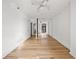 Bright bedroom with hardwood floors, mirrored closet doors, and a ceiling fan at 620 Peachtree Ne St # 1412, Atlanta, GA 30308