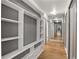 Hallway with wood floors, built-in shelving, mirrored wall, and recessed lighting at 620 Peachtree Ne St # 1412, Atlanta, GA 30308