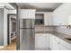 Well-lit kitchen featuring stainless steel appliances, white cabinets, granite countertops, and subway tile backsplash at 620 Peachtree Ne St # 1412, Atlanta, GA 30308