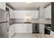 Bright kitchen with stainless steel appliances, white cabinets, and modern countertops at 620 Peachtree Ne St # 1412, Atlanta, GA 30308