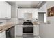 Modern kitchen with stainless steel oven, white cabinets, granite countertops and subway tile backsplash at 620 Peachtree Ne St # 1412, Atlanta, GA 30308