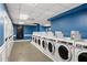 Clean laundry room with multiple washing machines and storage for added convenience at 620 Peachtree Ne St # 1412, Atlanta, GA 30308