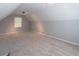 Attic/bonus room with natural lighting and neutral carpet at 714 Lanford Springs Sw Dr, Lilburn, GA 30047