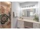 Bathroom features a large mirror, shower with floral curtain, and vanity with decor at 714 Lanford Springs Sw Dr, Lilburn, GA 30047