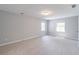 Spacious bedroom with neutral carpet, two windows, and two wall decor at 714 Lanford Springs Sw Dr, Lilburn, GA 30047