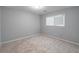 This bedroom has neutral carpet, natural lighting, and is freshly painted at 714 Lanford Springs Sw Dr, Lilburn, GA 30047