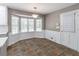 Sunlit breakfast nook with bay window, tile floor, and white door to the backyard at 714 Lanford Springs Sw Dr, Lilburn, GA 30047