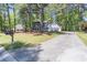 Suburban home nestled on a manicured lot, highlighted by a long driveway and mature trees at 714 Lanford Springs Sw Dr, Lilburn, GA 30047